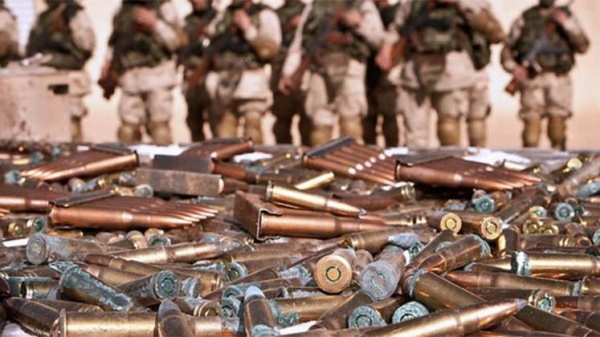 Bullets strewn in front of a line of soldiers