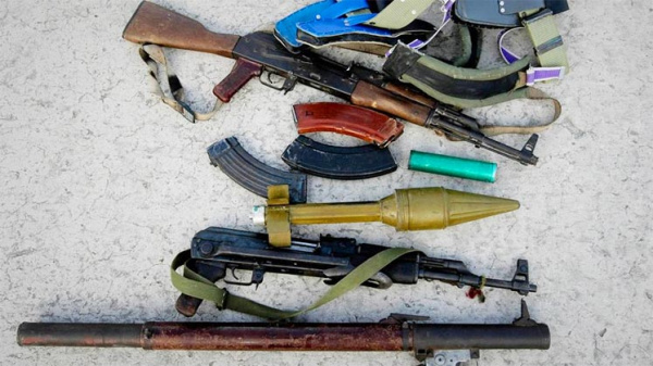 Rifles and RPGs strewn on the ground